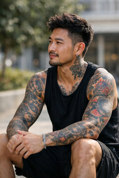 Contemplative Portrait: A poised individual with artistic body art sits outdoors, in a moment of tranquil reflection, embodying the essence of modern lifestyles.