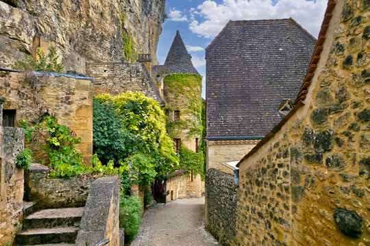 Beautiful street in the village of La Roque-Gageac, Dordogne, France with medieval vine covered turreted architecture