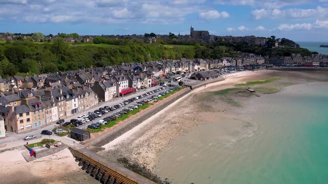 Cancale Brittany France 4k aerial drone sideway flight along scenic waterfront houses. Turquoise sea of emerald coast in Bretagne with traditional French architecture. Summer travel destination