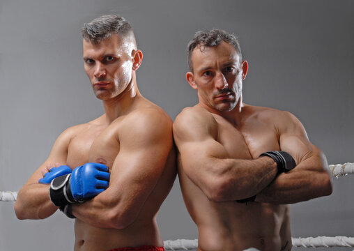 Two fighter or mixed martial artists ready for a fight posing before combat competition.