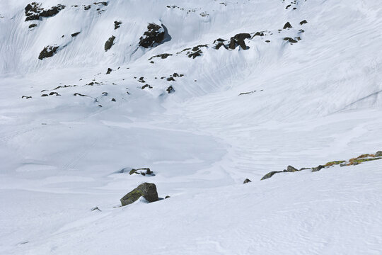 White surface of snow and rocks. Landscape abstract detail of structure and texture in the nature. Minimalism and minimalist shapes and lines.