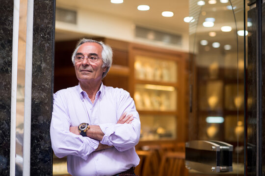 Middle Eastern man in jewelry store during wedding ring shopping with family and friends