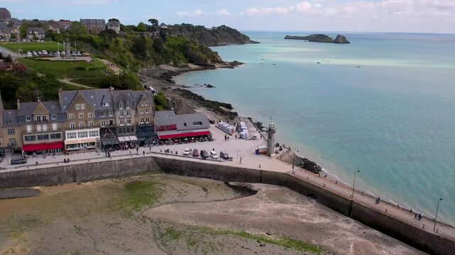 Cancale Brittany France 4k aerial drone scenic panorama reveal. Panning from lighthouse to oyster town cathedral on hill and coastline. Breathtaking Emerald Coast landscape in Bretagne. Famous French 