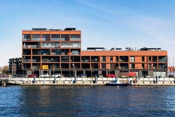 Obraz premium New block houses construction on the riverbank