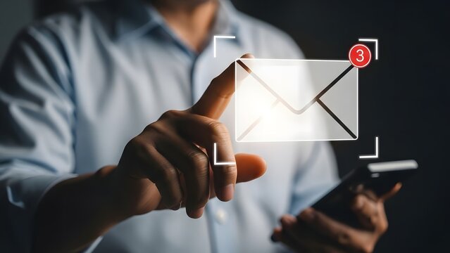 Person's finger is pointing at a glowing holographic email icon displaying an unread notification count, while simultaneously holding a modern smartphone in the other hand.