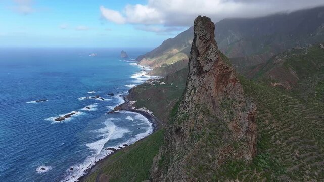 View from Roque de Las Animas cliff near the village of Taganana to the ocean coast and the village of Almaciga. Anaga Rural Park. Canary Islands. Tenerife. Aerial video. 4K 50fps.