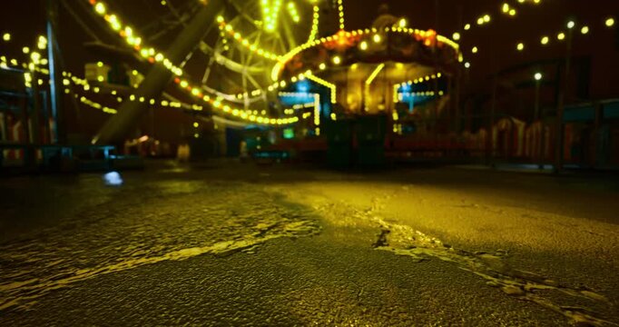 Colorful lights from carnival rides shine brightly in the night. The empty fairground reflects the vibrant hues, creating an enchanting yet eerie atmosphere. The ground shows wear and age.