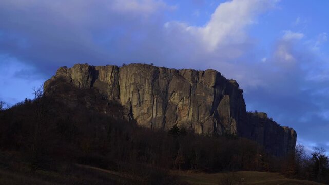 Time lapse video of the Pietra of Bismantova at sunset with a cloudy sky. Castelnuovo Monti, Reggio Emilia, Italy