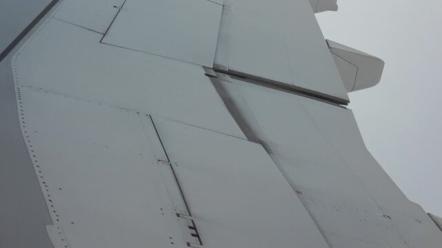 Detailed shot of one set of aircraft flaps in the twilight sky.