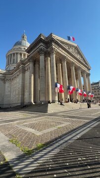 Pantheon columns framed by fluttering flags and shadow