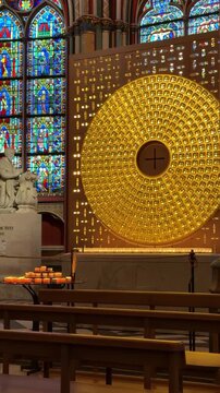 Quiet contemplation before golden votive circle cathedral interior