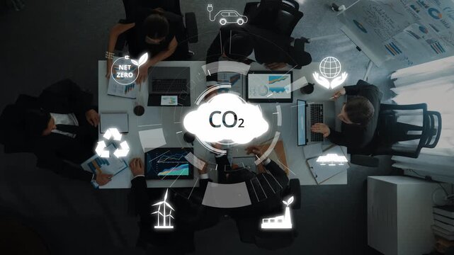 Professionals gather in a modern office to discuss carbon reduction strategies. The image emphasizes teamwork and innovative solutions for sustainability efforts. Raster