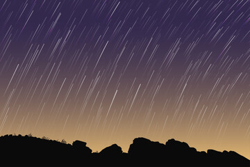 Yellow blue night sky, star trails. Landscape, rocky ground outline © arvitalya