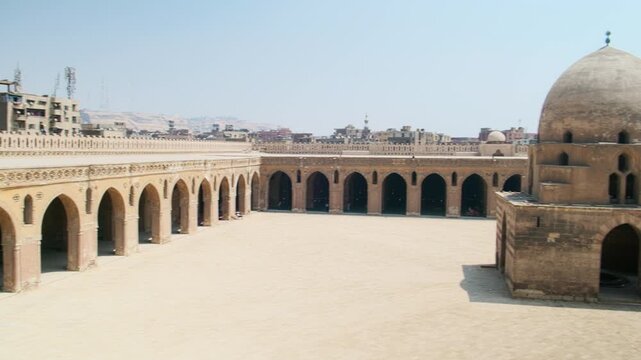 Panning footage overviewing courtyard of Ibn Tulun Mosque, oldest mosque located in Islamic Cairo, Egypt