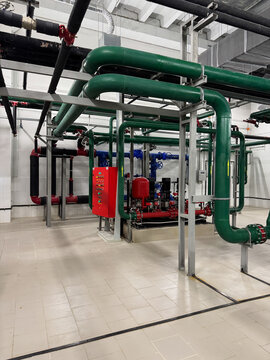 Heating system or Industrial boiler plant in separate room. System is equipped with various instruments. It consists of large boiler with a high-efficiency burner, pump, and tubes