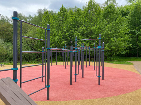 Outdoor calisthenics playground in city park with pull up bars and monkey bars. Outdoor workout and street training
