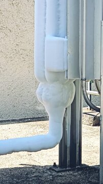Liquid oxygen cryogenic storage tank with frozen evaporator pipes in industrial facility