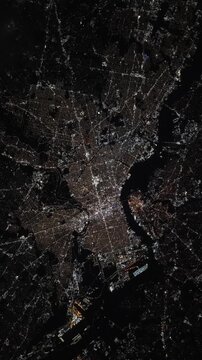 Vertical rotating over Philadelphia city at night with urban lights satellite view from space based on Nasa imagery