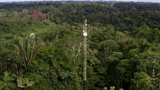 Puyo, Ecuador, 18-12-2021: Parabolic dish or satellite dish on an antenna placed on a hill top in the forest