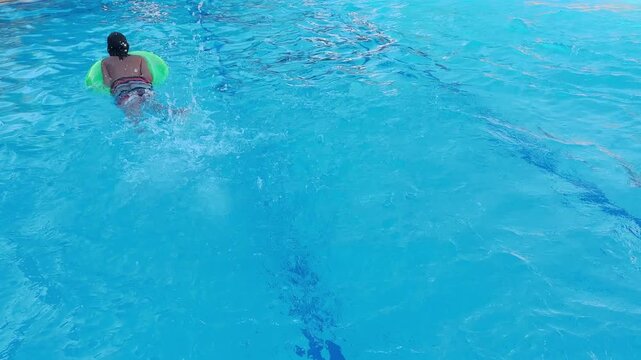 Preteen boy, child swimming in pool, enjoying water activity, summer fun, active lifestyle, healthy childhood, splashing water, outdoor leisure, Carefree childhood moment, Summer vacation fun