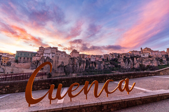 Cuenca Sign at Sunset with View of the Historic Old Town and San Pablo Bridge