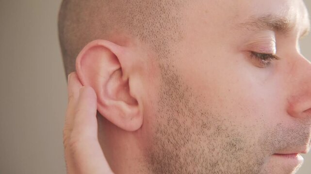 young man touching painful ear, discomfort and earache, healthcare problem, medical symptom acoustics Auditory System, Hearing Test, Cochlear implant, audiology support, ear health and deafness