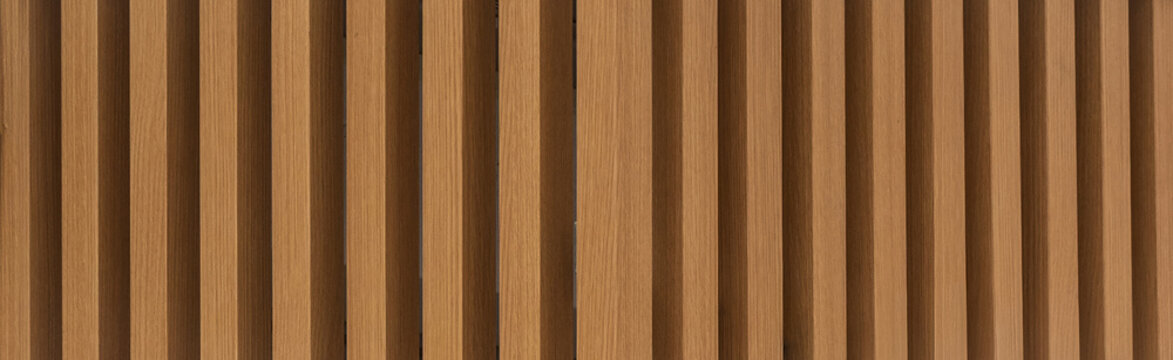 Modern architectural background of vertical wooden slats with natural grain and depth.