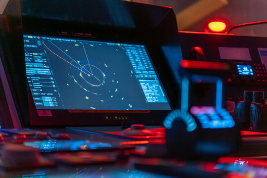Ship radar screen showing navigation track with bridge controls
