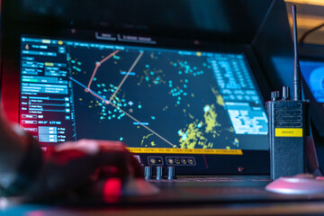 Radar navigation screen and VHF radio on ship bridge console © DMITRII RYBALKA