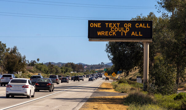 A digital traffic sign stating One Text or Call Could Wreck It All.  The image is from the 15 freeway in  Escondido Ca