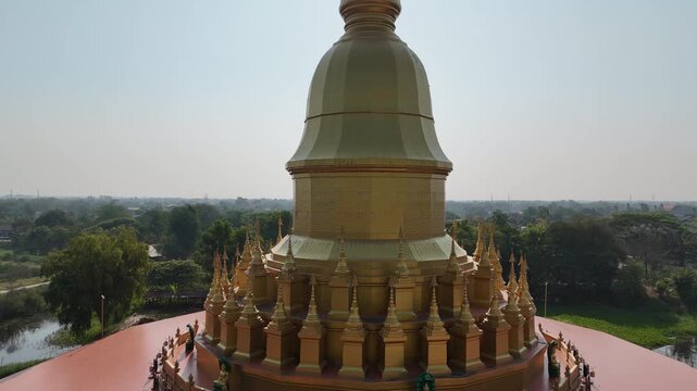 Wide aerial drone shot of Maha Chedi Sri Sarakham at sunset, Maha Sarakham, Thailand.