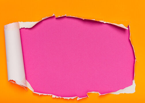 Vibrant yellow paper with a large ripped hole revealing a pink textured background.