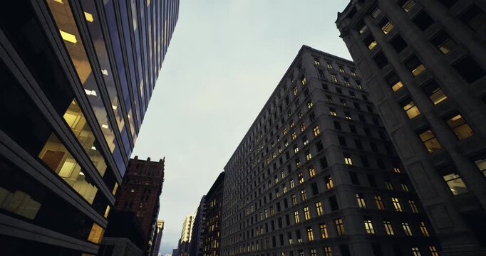 urban grid corridor stretching toward distant dusk skyline, symmetrical building rows and glowing windows create cinematic vanishing point, metropolitan calm