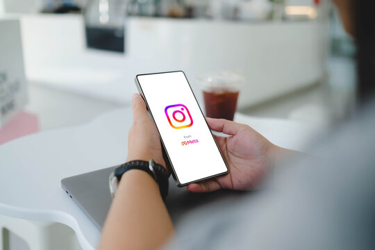 Bangkok, Thailand. April 13, 2026; A person holds a smartphone that displays the Instagram and Meta company logos on the screen while sitting at a cafe.