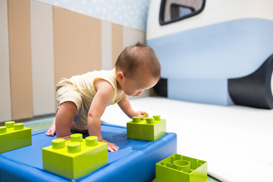 Cute little boy enjoy block game in playhouse