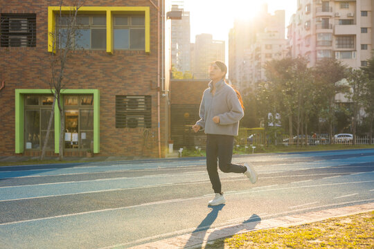 Female athlete running on track field during workout