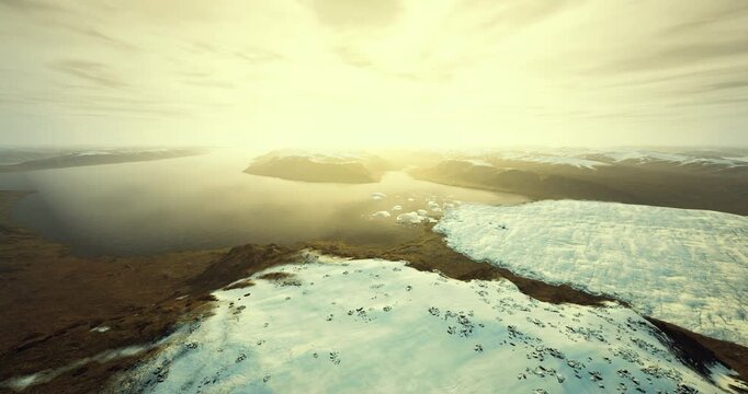 Sunlit ice edge with greenish algae tint, dramatic close aerial perspective showing texture, cracks, and scattered icebergs, emphasis on ecological indicators