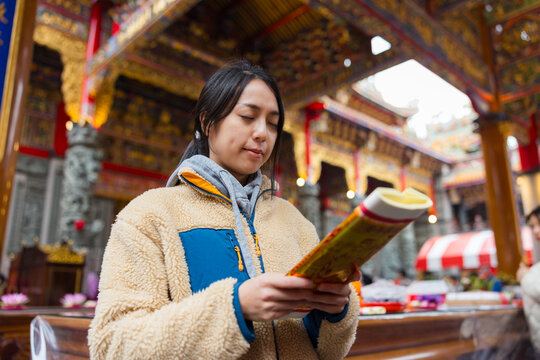 Woman praying and worshiping at traditional temple