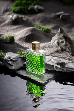 Unisex green perfume in an oasis on stony black desert.