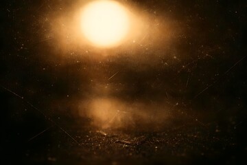 Fototapeta premium Bright golden light glowing softly in the dark texture with vintage scratch marks and dust particles for artistic backgrounds