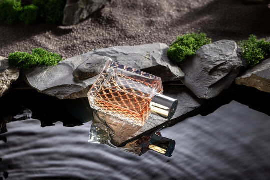 Untamed golden perfume illuminated by moonlight on black water.