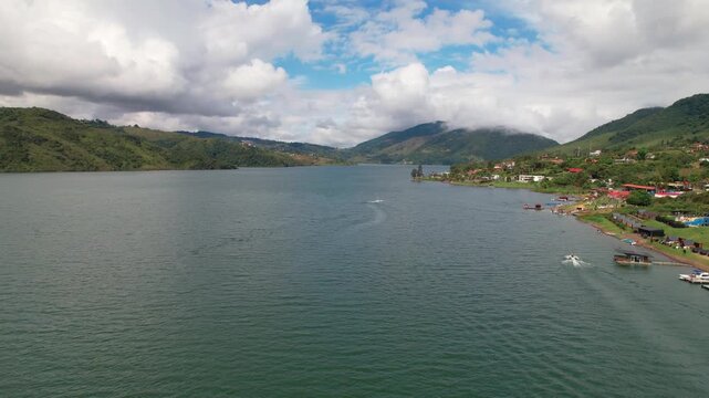 Aerial view flying over tropical mountain lake landscape