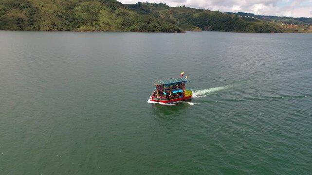 Tourist party boat sailing on a beautiful mountain lake