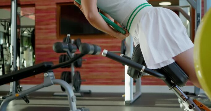 Woman Performing Hyperextensions in Gym Setting