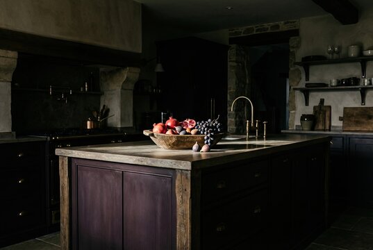 Dramatic Aubergine Kitchen Island with Rustic Fruit Bowl under Spotlight
