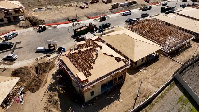 Aerial Orbit of a Busy Residential Housing Construction Site with Building Development Activity.