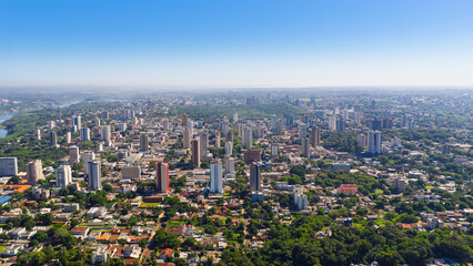 Fototapeta premium Aerial view of Foz do Iguaçu city with dense urban area surrounded by greenery in Paraná, Brazil.
