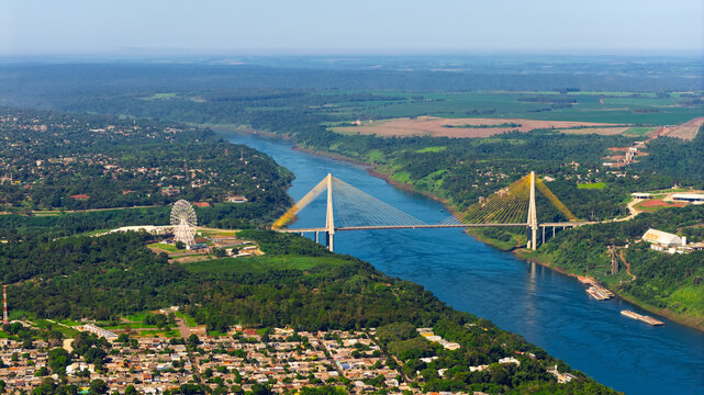 Aerial close up of Integration Bridge and Ferris wheel over Parana River at Brazil Paraguay border.