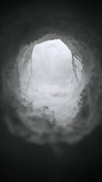 Mysterious subterranean tunnel filled with a wispy haze. Wind blowing and swirling through an eerie fog filled cave. Ominous cavern opening to spooky old burrow, underground sewer, or dugout.
