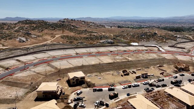 Aerial Orbit of a Busy Residential Housing Construction Site with Building Development Activity.